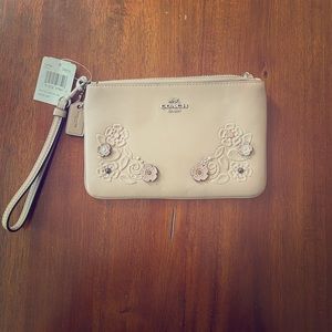 Brand new Coach wristlet. Tan/nude in color.